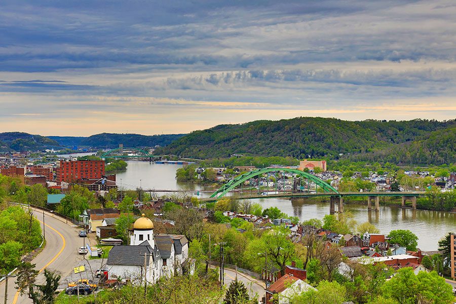 Columbiana, OH - Aerial View of Wheeling, West Virginia Along the Ohio River Displaying buildings and Mountain Range in the Background