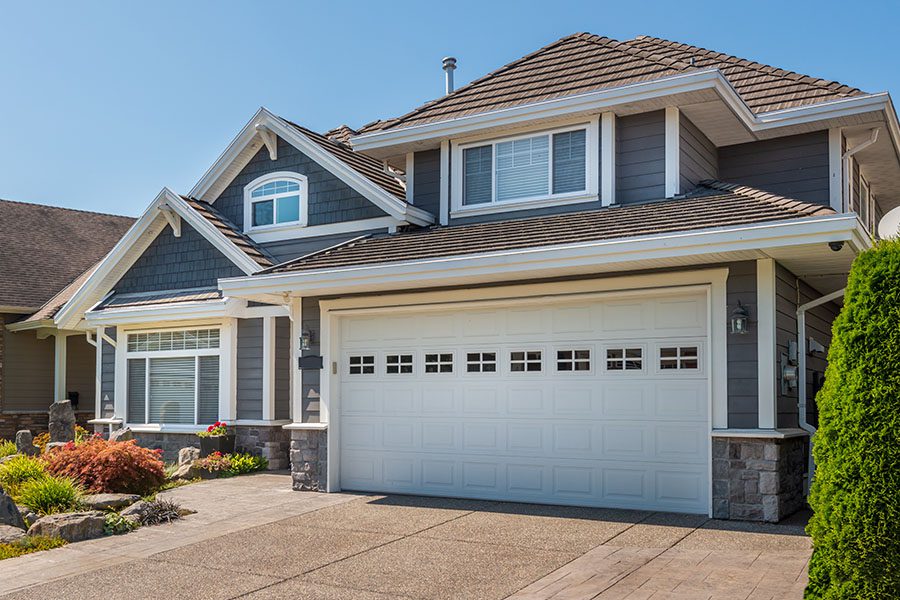 Specialized Business Insurance - View of New Blue Colonial House in Suburb at Summer in the North America